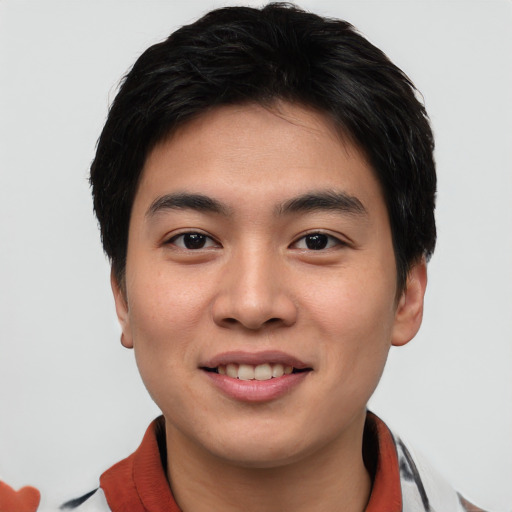 Joyful asian young-adult male with short  black hair and brown eyes