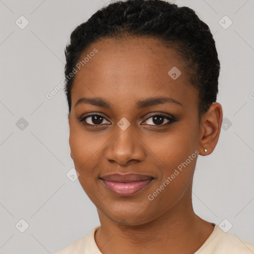 Joyful black young-adult female with short  black hair and brown eyes