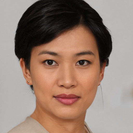 Joyful asian young-adult female with short  brown hair and brown eyes