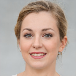 Joyful white young-adult female with medium  brown hair and blue eyes