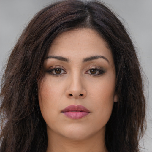 Joyful asian young-adult female with long  brown hair and brown eyes