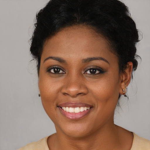 Joyful black young-adult female with medium  brown hair and brown eyes