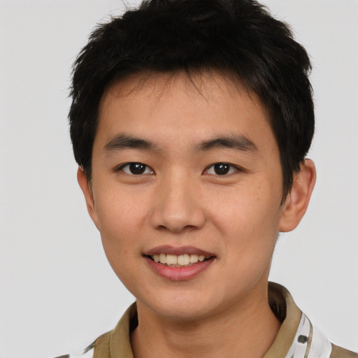 Joyful white young-adult male with short  black hair and brown eyes