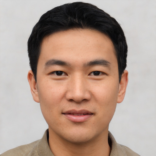 Joyful asian young-adult male with short  black hair and brown eyes