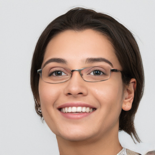 Joyful white young-adult female with medium  brown hair and brown eyes