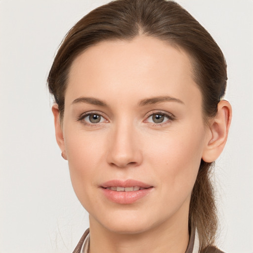 Joyful white young-adult female with long  brown hair and grey eyes