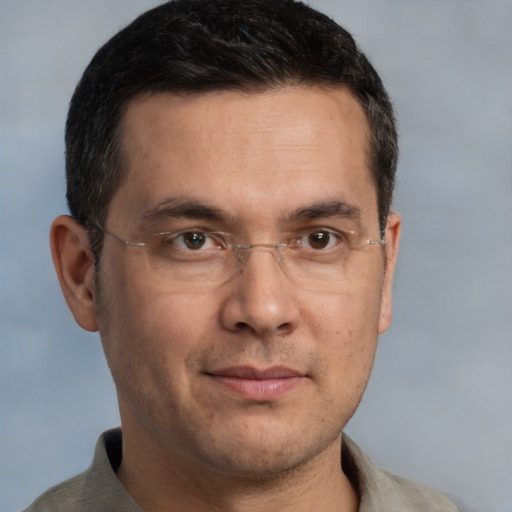 Joyful white adult male with short  brown hair and brown eyes