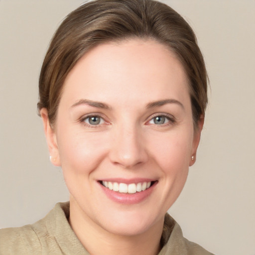 Joyful white young-adult female with short  brown hair and grey eyes