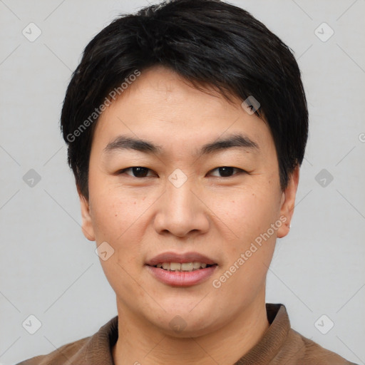 Joyful asian young-adult male with short  black hair and brown eyes