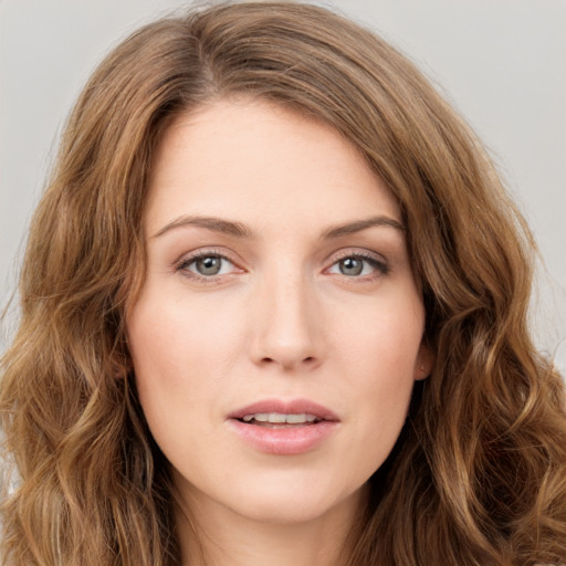 Joyful white young-adult female with long  brown hair and green eyes