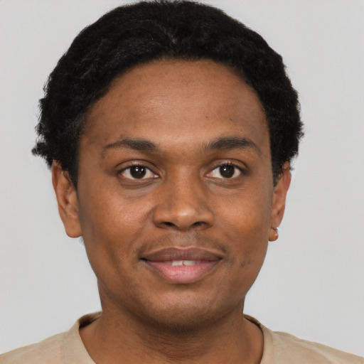 Joyful black young-adult male with short  black hair and brown eyes