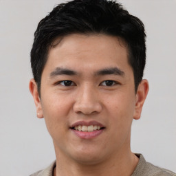 Joyful asian young-adult male with short  black hair and brown eyes