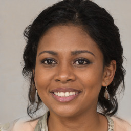 Joyful black young-adult female with medium  brown hair and brown eyes