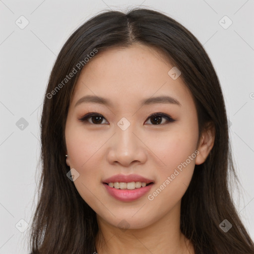 Joyful asian young-adult female with long  brown hair and brown eyes