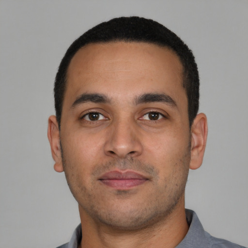 Neutral latino young-adult male with short  brown hair and brown eyes