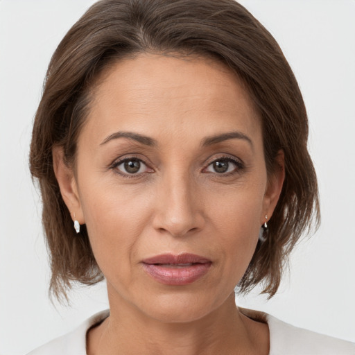 Joyful white adult female with medium  brown hair and brown eyes