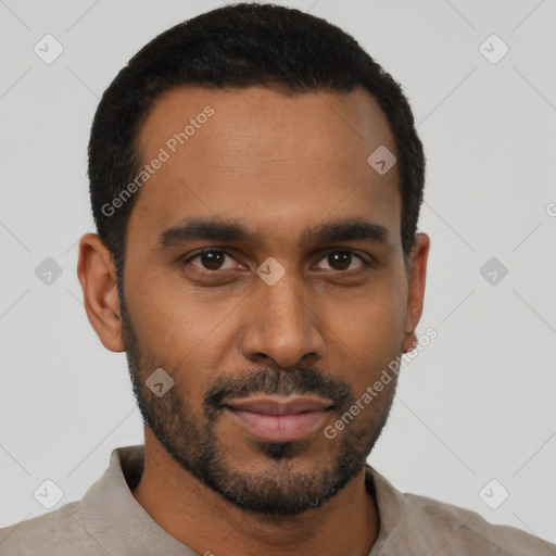 Joyful black young-adult male with short  black hair and brown eyes