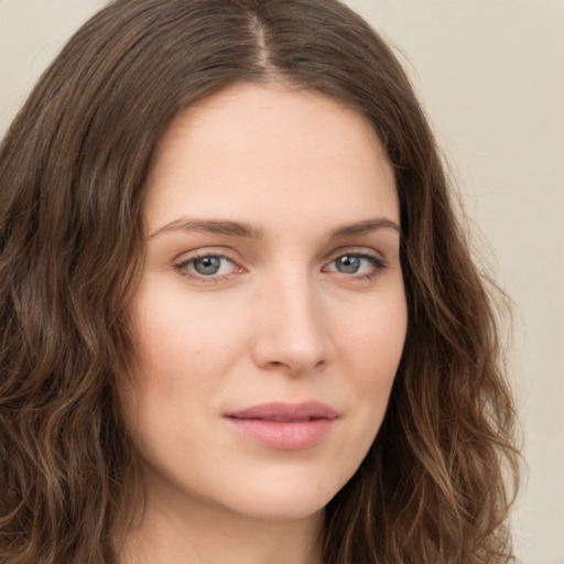 Joyful white young-adult female with long  brown hair and green eyes