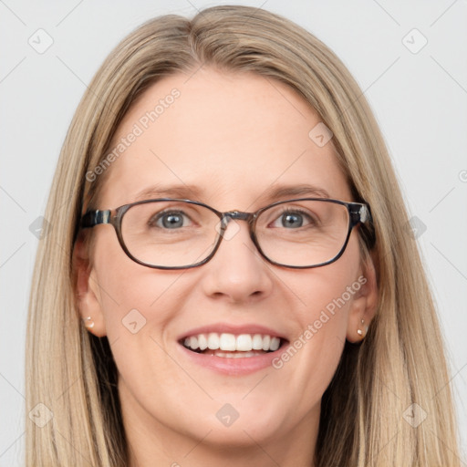 Joyful white adult female with long  brown hair and blue eyes