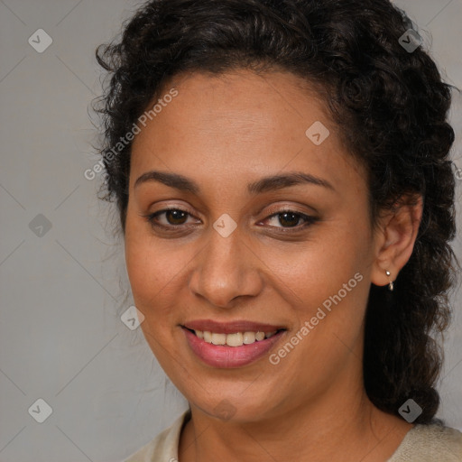 Joyful latino adult female with medium  brown hair and brown eyes