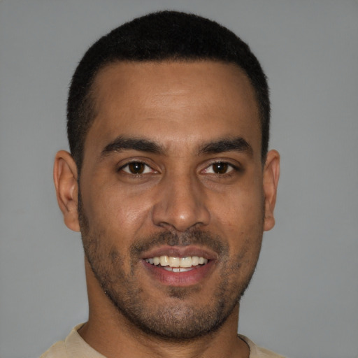 Joyful black young-adult male with short  brown hair and brown eyes