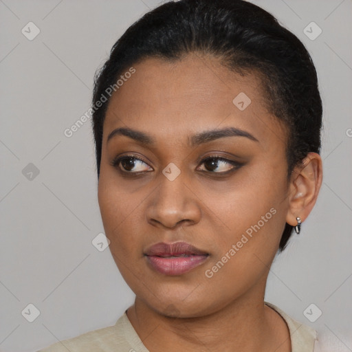 Joyful black young-adult female with short  brown hair and brown eyes