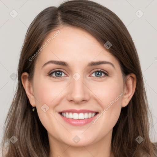 Joyful white young-adult female with long  brown hair and grey eyes