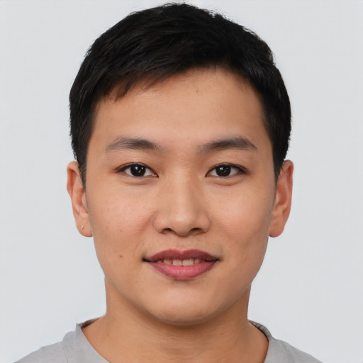 Joyful asian young-adult male with short  black hair and brown eyes