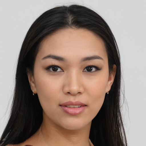 Joyful asian young-adult female with long  black hair and brown eyes