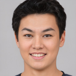 Joyful asian young-adult male with short  brown hair and brown eyes