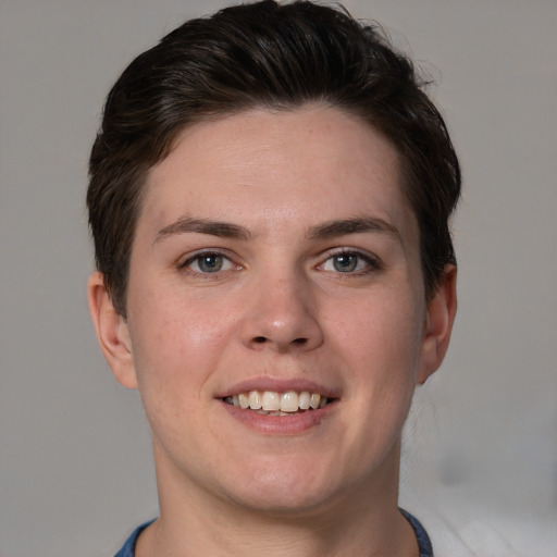 Joyful white young-adult female with short  brown hair and grey eyes