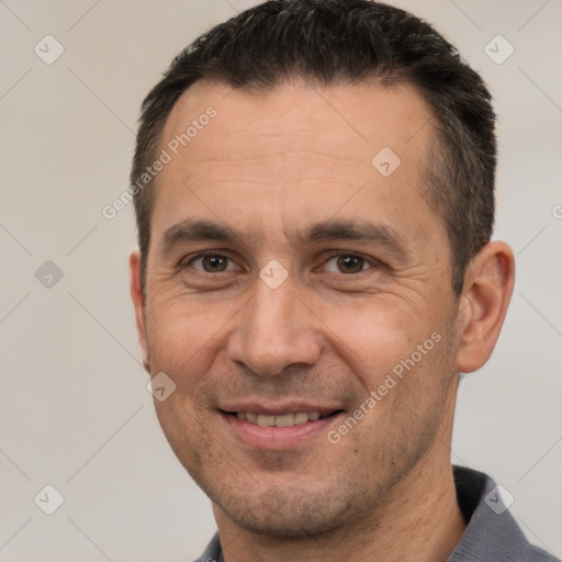 Joyful white adult male with short  brown hair and brown eyes