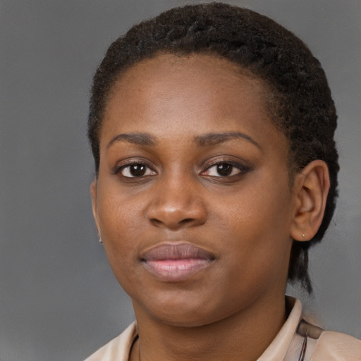 Joyful black young-adult female with short  brown hair and brown eyes