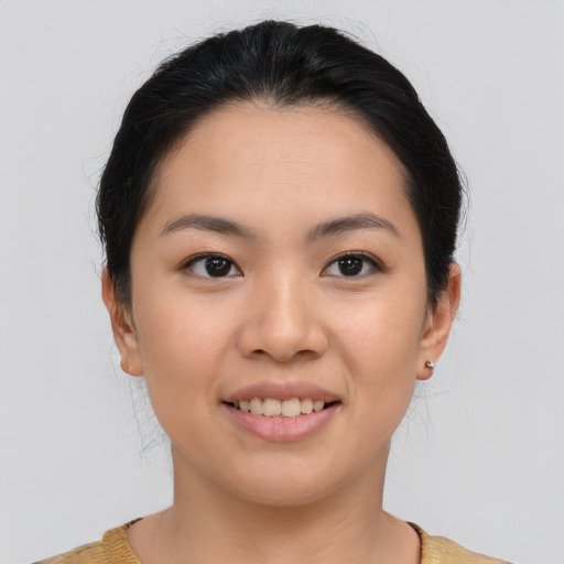 Joyful asian young-adult female with medium  brown hair and brown eyes