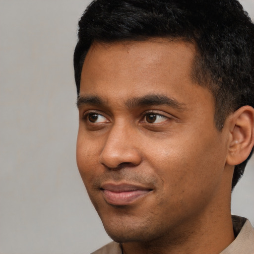 Neutral black young-adult male with short  black hair and brown eyes