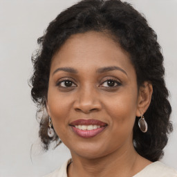 Joyful black adult female with medium  brown hair and brown eyes