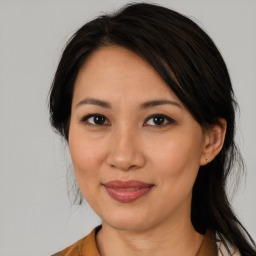 Joyful asian adult female with medium  brown hair and brown eyes