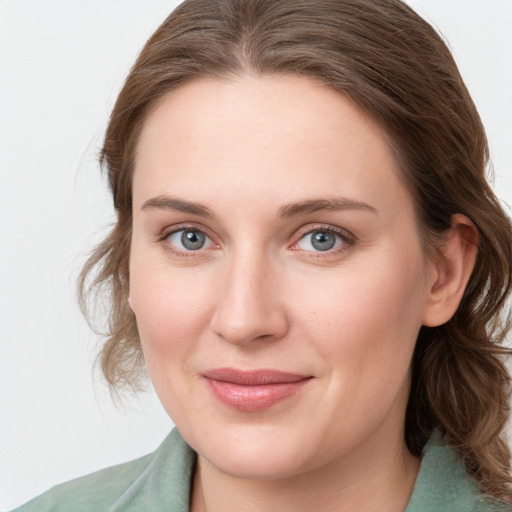 Joyful white young-adult female with medium  brown hair and blue eyes