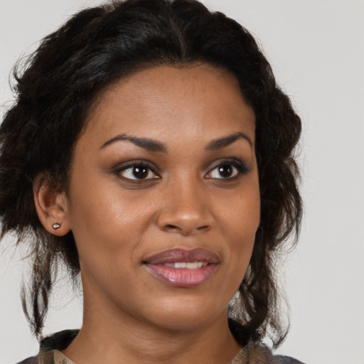 Joyful black young-adult female with medium  brown hair and brown eyes