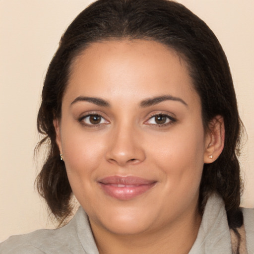 Joyful white young-adult female with medium  brown hair and brown eyes