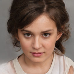 Joyful white child female with medium  brown hair and brown eyes