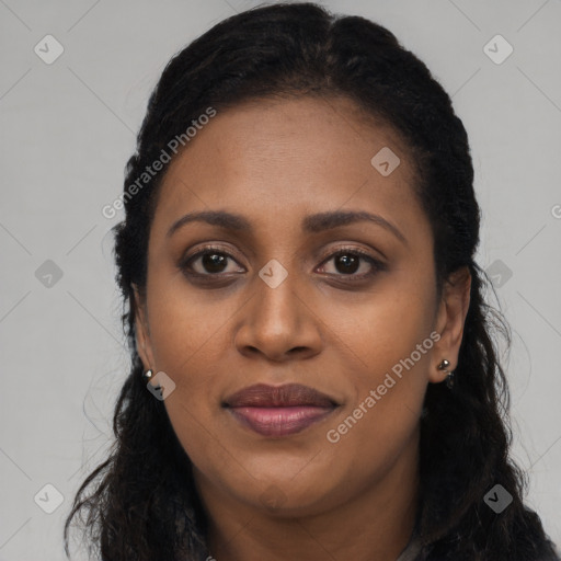 Joyful black young-adult female with long  black hair and brown eyes