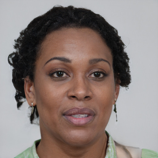Joyful black adult female with short  brown hair and brown eyes