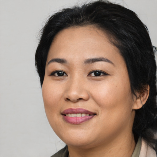 Joyful asian young-adult female with medium  black hair and brown eyes