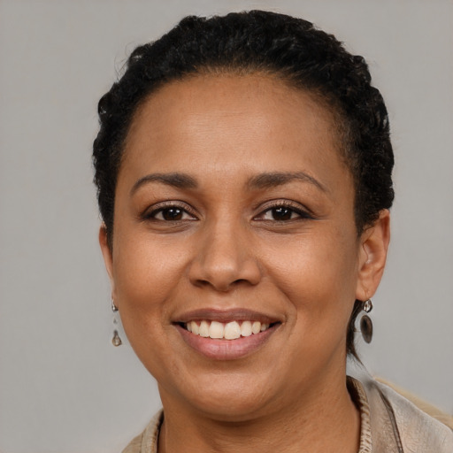 Joyful latino adult female with short  brown hair and brown eyes