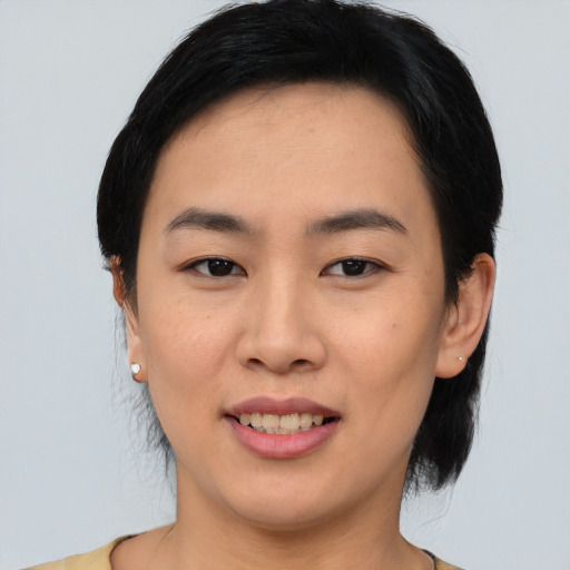 Joyful asian young-adult female with medium  black hair and brown eyes