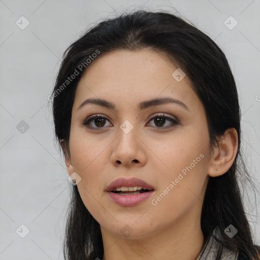 Joyful asian young-adult female with long  black hair and brown eyes