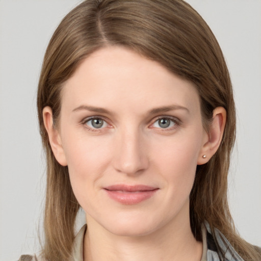 Joyful white young-adult female with long  brown hair and grey eyes