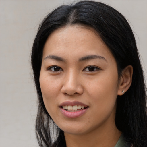Joyful asian young-adult female with long  black hair and brown eyes