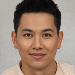 Joyful latino young-adult male with short  brown hair and brown eyes